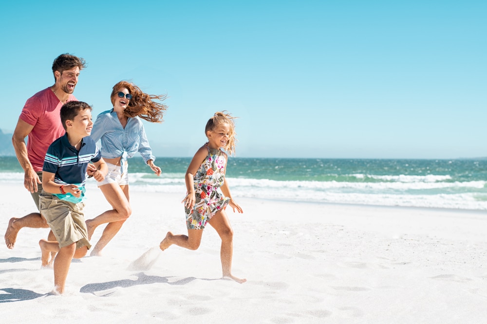 Familie tobt am Strand